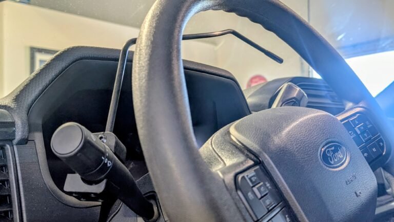 Turn signal extension rod installed on a Ford F-150 steering column for easier reach